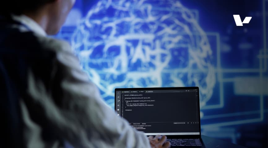 A developer writing code on a laptop with a digital brain image in the background, symbolizing the integration of artificial intelligence and programming.