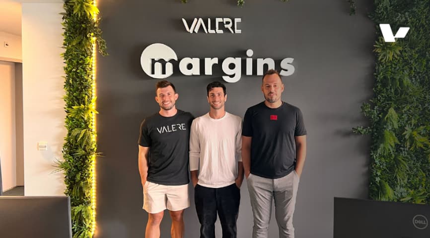 Three members of the Valere team standing in front of their company sign, representing the AI-driven software development powerhouse based in Croatia.