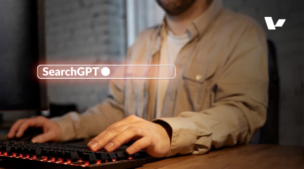 A person typing on a keyboard with the SearchGPT search bar visible on the screen, representing AI-powered search technology.