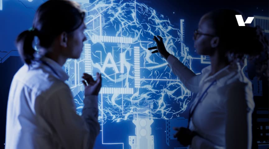 Two professionals discussing artificial intelligence in front of a futuristic digital display featuring a glowing neural network and the letters "AI".