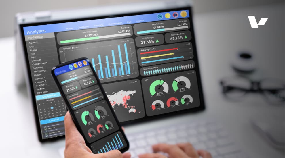 An analytical dashboard on both a desktop screen and mobile phone displaying key performance indicators (KPIs), monthly sales, and various business metrics for tracking company performance and growth.