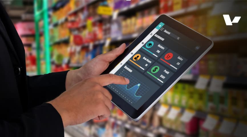 The image shows a person using a tablet with a dashboard interface in a retail store setting. The dashboard displays various analytics