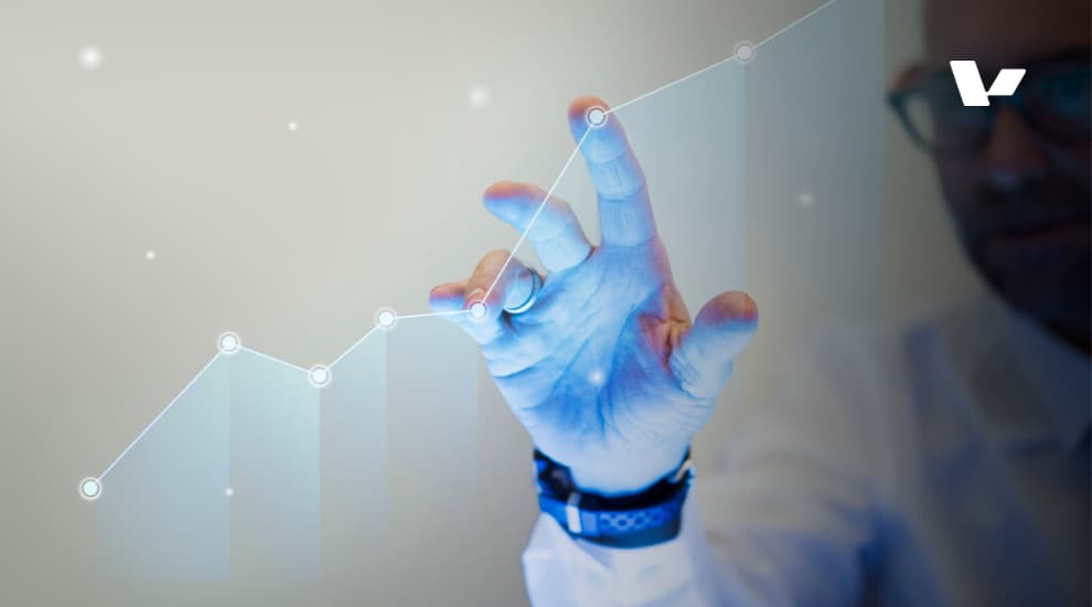 A business professional interacting with a digital graph on a touchscreen, symbolizing business growth and scalability. The graph shows an upward trend, indicating positive performance and development.